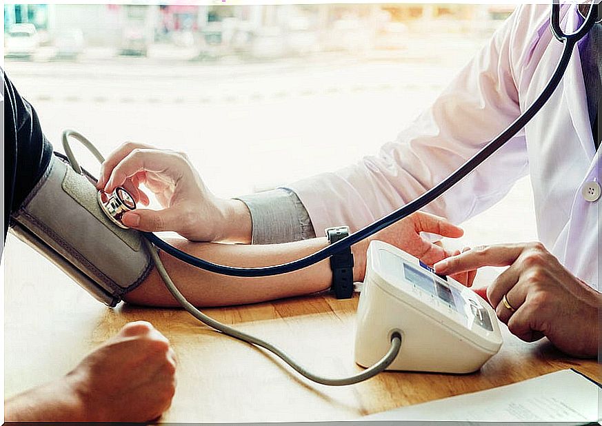 Doctor measuring blood pressure to a patient.