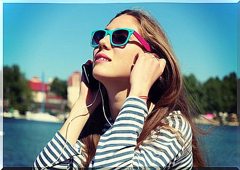 Woman listening to music with headphones.