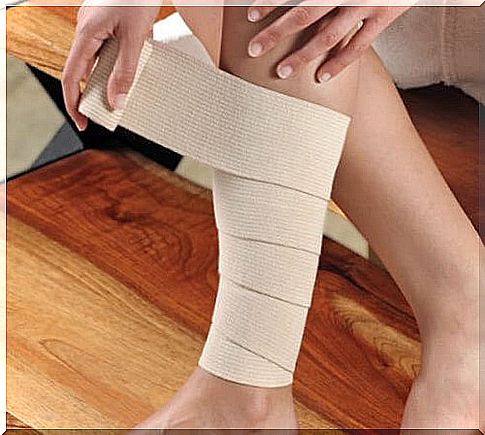 person bandaging leg