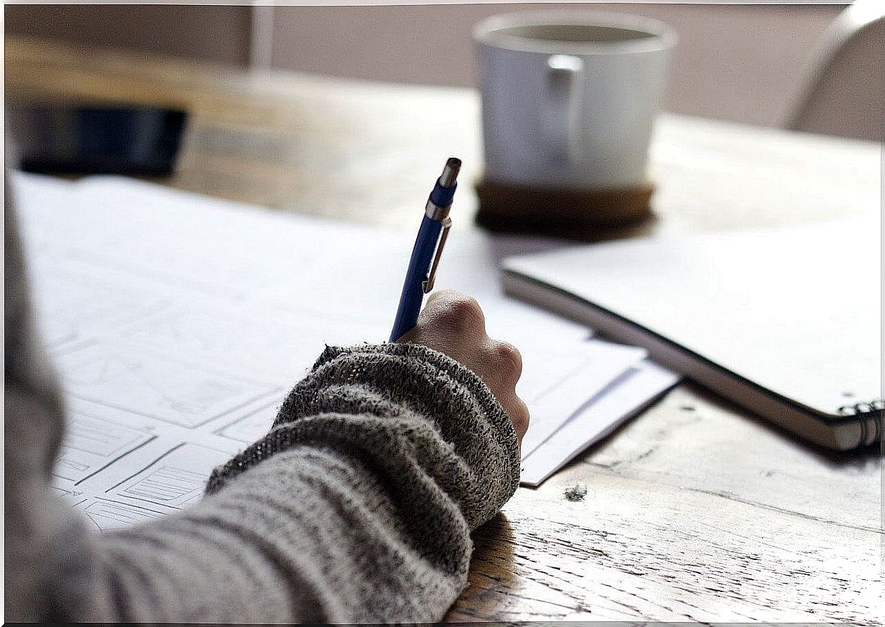 Woman writing resolutions in a notebook.