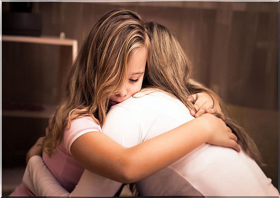 Mother hugging her tearful daughter