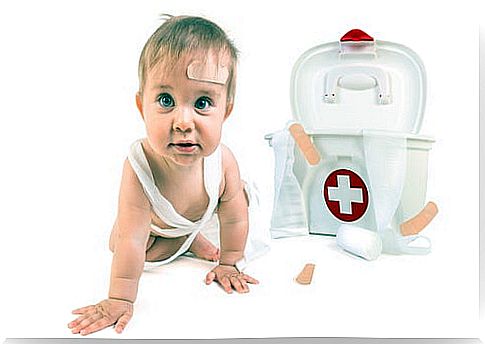 Baby next to a first aid kit