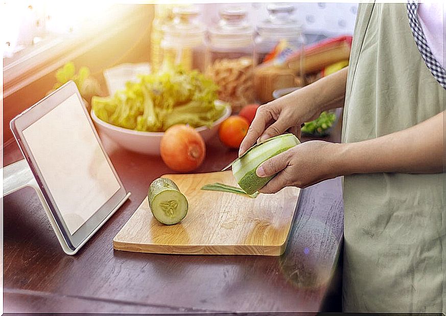 Cooking looking at a tablet