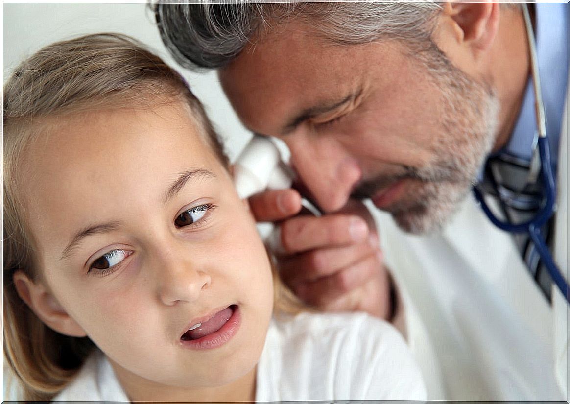 Doctor examines little girl's ear