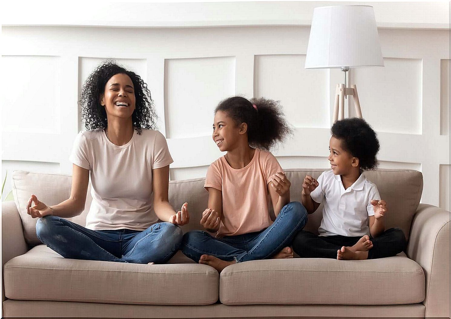 Mother with her children laughing and meditating.