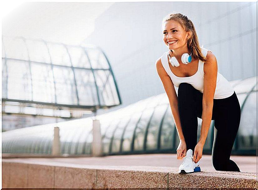 Girl tying her shoes about to run.